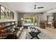 Cozy living room with plush leather seating, travertine floors, modern lighting, and outdoor views at 7714 N 17Th Pl, Phoenix, AZ 85020