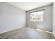 Bright room featuring a window, plank floors, and light gray walls at 8061 E Glenrosa Ave, Scottsdale, AZ 85251