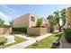 Exterior view of the condo with a well-maintained lawn and a private, walled patio area at 8061 E Glenrosa Ave, Scottsdale, AZ 85251