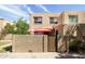 Charming condo featuring a private courtyard with red patio umbrellas and stylish wood gate at 8061 E Glenrosa Ave, Scottsdale, AZ 85251