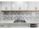 Updated kitchen featuring a stainless steel sink, modern faucet, and mosaic tile backsplash at 8061 E Glenrosa Ave, Scottsdale, AZ 85251