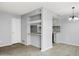 Open-concept living area with updated floors, gray walls, and a breakfast bar leading to the kitchen at 8061 E Glenrosa Ave, Scottsdale, AZ 85251