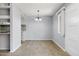 Open-concept living and dining space with new wood floors, neutral paint, and a modern light fixture at 8061 E Glenrosa Ave, Scottsdale, AZ 85251