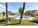 Community pool with tables, chairs, and mature palm trees in a meticulously maintained outdoor space at 8061 E Glenrosa Ave, Scottsdale, AZ 85251
