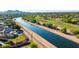 Scenic aerial view showcasing a tranquil canal and neighboring golf course at 8502 E Malcomb Dr, Scottsdale, AZ 85250