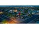 Night aerial view of neighborhood and house with a sparkling cityscape and mountain backdrop at 8502 E Malcomb Dr, Scottsdale, AZ 85250