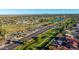 Aerial view showcases the neighborhood with lush greenery, parks, and a lake at 8502 E Malcomb Dr, Scottsdale, AZ 85250