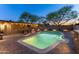 The backyard features a pool, a covered patio with bar, outdoor seating and brick pavers throughout at 8502 E Malcomb Dr, Scottsdale, AZ 85250