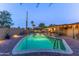 Large backyard with a pool, a covered patio with bar and barbecue, and brick pavers throughout at 8502 E Malcomb Dr, Scottsdale, AZ 85250