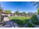 Expansive backyard featuring lush green grass, gazebo with grill, and brick paver patio at 8502 E Malcomb Dr, Scottsdale, AZ 85250