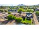 Private backyard with a covered patio, lush green lawn, and refreshing pool at 8502 E Malcomb Dr, Scottsdale, AZ 85250