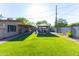 Spacious backyard with mature landscaping, a well-manicured lawn, and outdoor dining area at 8502 E Malcomb Dr, Scottsdale, AZ 85250