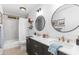 Stylish bathroom with a double vanity, modern mirrors, and tiled shower/tub at 8502 E Malcomb Dr, Scottsdale, AZ 85250