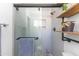 Walk-in shower in modern bathroom with stylish fixtures and industrial shelving for storage at 8502 E Malcomb Dr, Scottsdale, AZ 85250