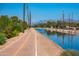 Paved canal trail offering a scenic route for recreation and exercise with mountain views in the background at 8502 E Malcomb Dr, Scottsdale, AZ 85250