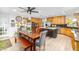 An open concept kitchen and dining area with wood cabinets, a large island, and stainless steel appliances at 8502 E Malcomb Dr, Scottsdale, AZ 85250