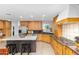 A large eat-in kitchen with wood cabinets, a granite island, and stainless steel appliances at 8502 E Malcomb Dr, Scottsdale, AZ 85250