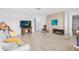 Open living room with white couch, fireplace, mounted TV, and light wood-look floors at 8502 E Malcomb Dr, Scottsdale, AZ 85250