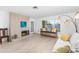 Bright living room featuring a brick fireplace, light-toned wood floors, and comfortable seating at 8502 E Malcomb Dr, Scottsdale, AZ 85250