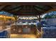 Outdoor kitchen area featuring a built-in barbecue grill, a bar, stone accents and a covered area at 8502 E Malcomb Dr, Scottsdale, AZ 85250
