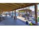Inviting covered outdoor space with dining, lounge area, BBQ and stone pillars at 8502 E Malcomb Dr, Scottsdale, AZ 85250
