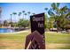Chaparral Park sign with lake, green grass and palm trees in the background at 8502 E Malcomb Dr, Scottsdale, AZ 85250