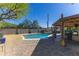Relaxing backyard oasis with a sparkling pool and covered patio, ideal for entertaining at 8502 E Malcomb Dr, Scottsdale, AZ 85250