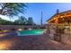 A spacious backyard pool area, complete with a built-in bar, a covered patio, and ample outdoor seating at 8502 E Malcomb Dr, Scottsdale, AZ 85250