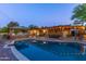Inviting backyard pool area with a covered patio, a bar, a barbecue and a well-manicured patio at 8502 E Malcomb Dr, Scottsdale, AZ 85250