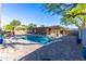 Gorgeous pool and outdoor space complete with a covered patio, bar, and BBQ area at 8502 E Malcomb Dr, Scottsdale, AZ 85250