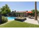 Relaxing backyard oasis with sparkling pool, patio, seating, and lush landscaping, perfect for outdoor living at 8502 E Rose Ln, Scottsdale, AZ 85250