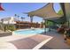 Inviting backyard with a refreshing pool, covered patio, and lounge chairs, ideal for relaxation and entertaining at 8502 E Rose Ln, Scottsdale, AZ 85250