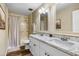 Spacious bathroom with double vanity, granite countertop, modern fixtures, and shower featuring a shower curtain at 8502 E Rose Ln, Scottsdale, AZ 85250