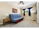 Bright bedroom featuring a comfortable futon, neutral decor, and ample natural light from a window at 8502 E Rose Ln, Scottsdale, AZ 85250