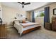 Cozy bedroom featuring a comfortable bed, neutral decor, and ample natural light from a window at 8502 E Rose Ln, Scottsdale, AZ 85250