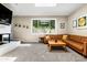 Comfortable living room with a brick fireplace, large window, and plush carpeting at 8502 E Rose Ln, Scottsdale, AZ 85250