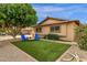 Charming backyard area with artificial turf, perfect for seating, complemented by gravel and well-maintained landscaping at 8644 E Roanoke Ave, Scottsdale, AZ 85257
