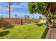 Lush backyard featuring block fence, mature trees, and manicured lawn at 8644 E Roanoke Ave, Scottsdale, AZ 85257