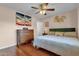 Well-appointed bedroom with hardwood floors, a ceiling fan, and a classic dresser, creating a relaxing retreat at 8644 E Roanoke Ave, Scottsdale, AZ 85257