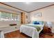 Cozy bedroom with hardwood floors, a large window, and a comfortable bed, providing a peaceful retreat at 8644 E Roanoke Ave, Scottsdale, AZ 85257