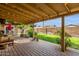 Inviting covered patio with brick flooring, string lights, and a view of the landscaped backyard, ideal for relaxing at 8644 E Roanoke Ave, Scottsdale, AZ 85257