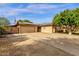 A single-story home features solar panels, a two-car garage, and a gated driveway at 8644 E Roanoke Ave, Scottsdale, AZ 85257
