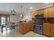 Kitchen area featuring stainless appliances, wood cabinetry and tile flooring at 8644 E Roanoke Ave, Scottsdale, AZ 85257