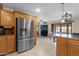 Bright kitchen showcasing wood cabinetry, stainless fridge and open floor plan at 8644 E Roanoke Ave, Scottsdale, AZ 85257