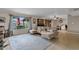 Bright living room with a large window overlooking the backyard, showcasing a comfortable seating area and tile flooring at 8644 E Roanoke Ave, Scottsdale, AZ 85257