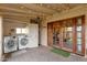 An outdoor laundry area opens onto a patio with wooden french doors at 8644 E Roanoke Ave, Scottsdale, AZ 85257