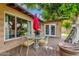 A backyard patio features a round glass table, four chairs, and an umbrella at 8644 E Roanoke Ave, Scottsdale, AZ 85257
