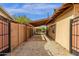 A gated side yard features a covered walkway and gravel at 8644 E Roanoke Ave, Scottsdale, AZ 85257