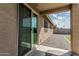 Covered patio leading to an enclosed backyard with artificial turf and easy to maintain gravel at 8715 W Agora Ln, Tolleson, AZ 85353
