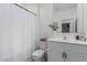 Bright white bathroom with a shower and stylish vanity with a sink and a mirror at 8715 W Agora Ln, Tolleson, AZ 85353